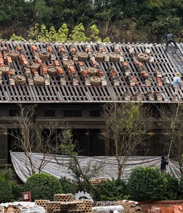 Roofers repairing tiled roof on scaffolding at a Cape Town property